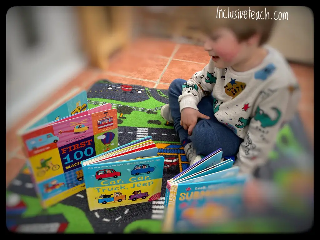 Child with three books on transport themed rug eyfs
