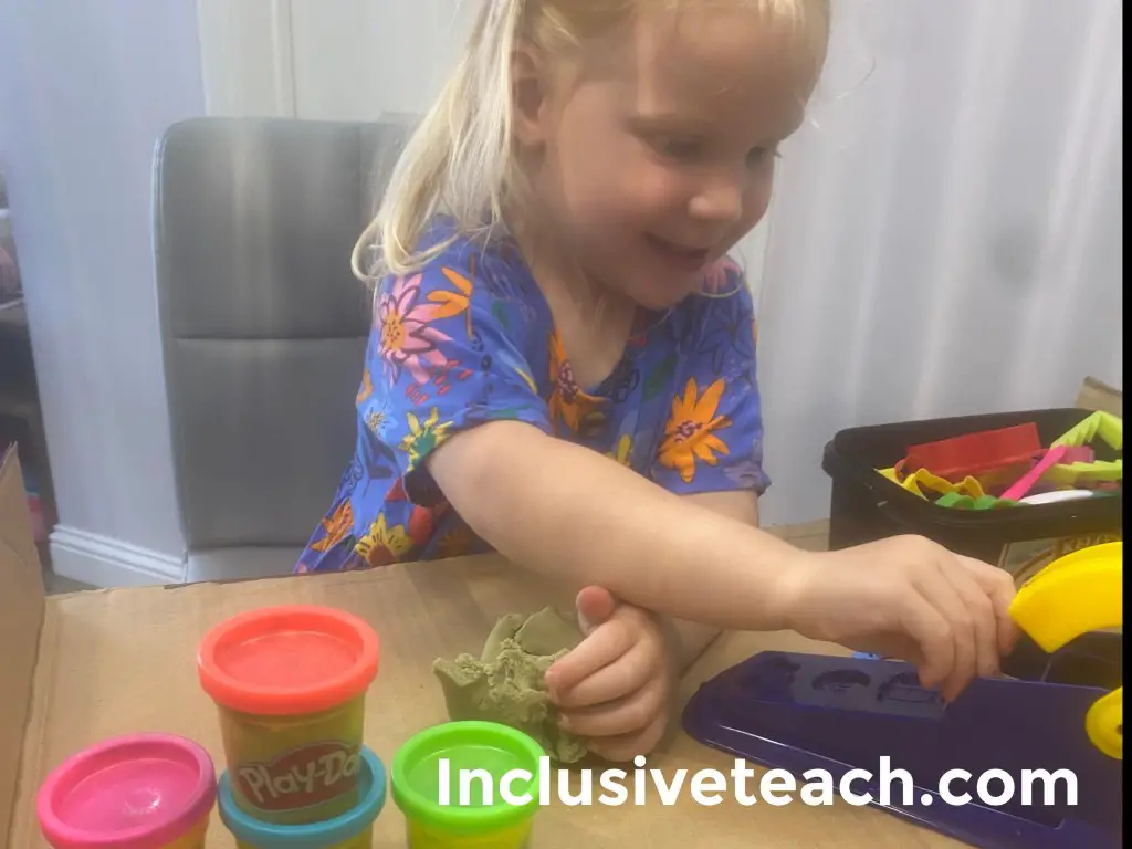 toddler playing with dough learning EYFS Play-doh
