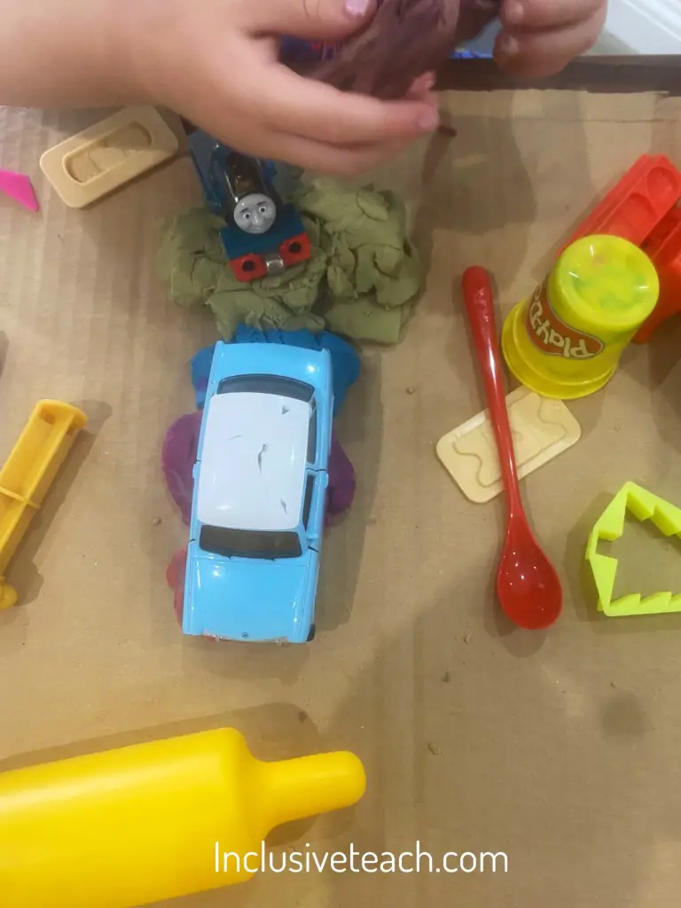 Creativity playing with dough adding props for fine motor skill development